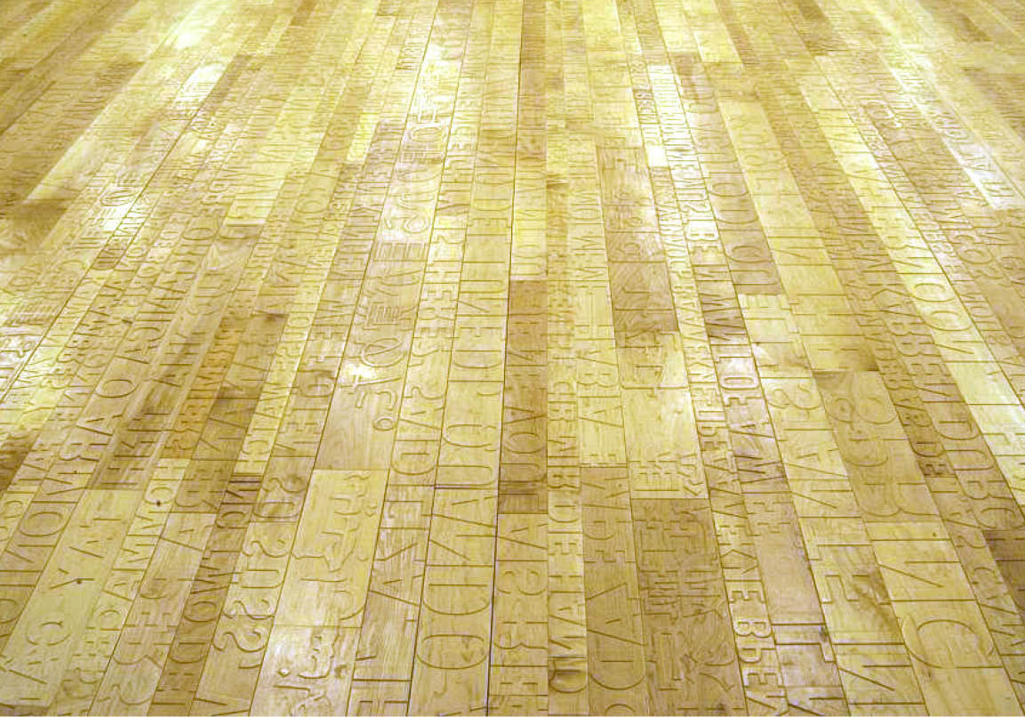 Photo of hardwood floor with raised letters.