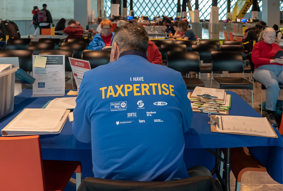 Tax help volunteer wearing a t-shirt that says “I have taxpertise."