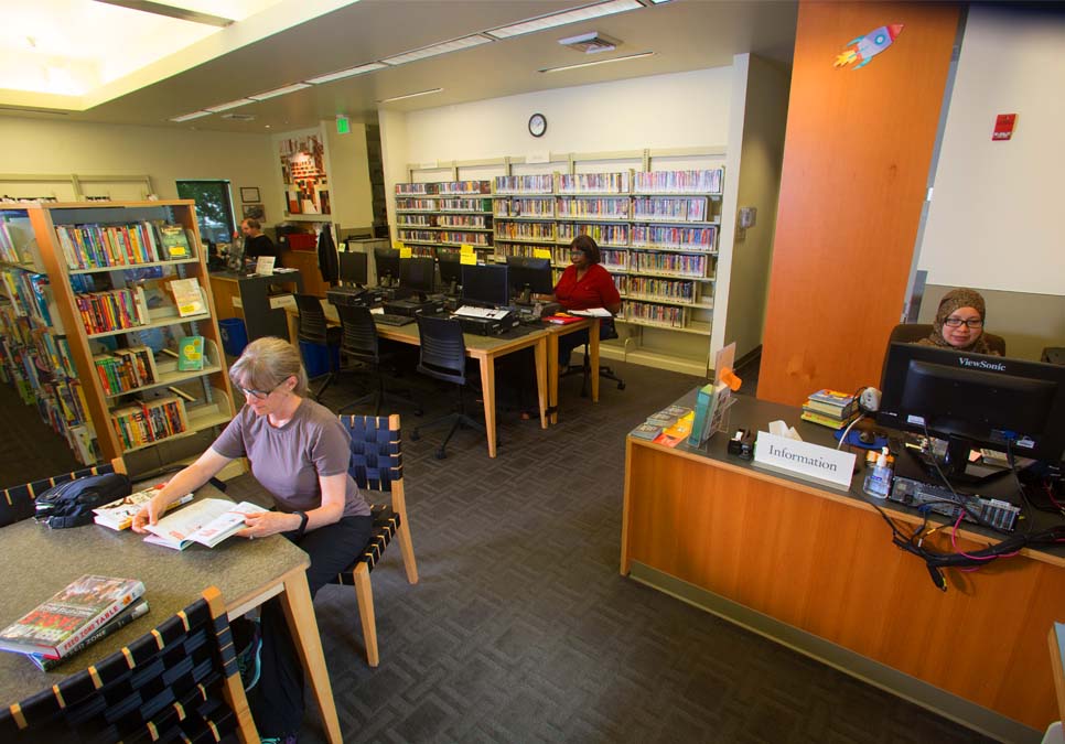 Library staff at the service desk area at the Madrona-Sally Goldmark Branch