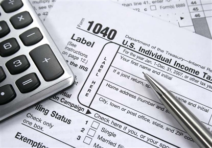 tax paper, pen and calculator