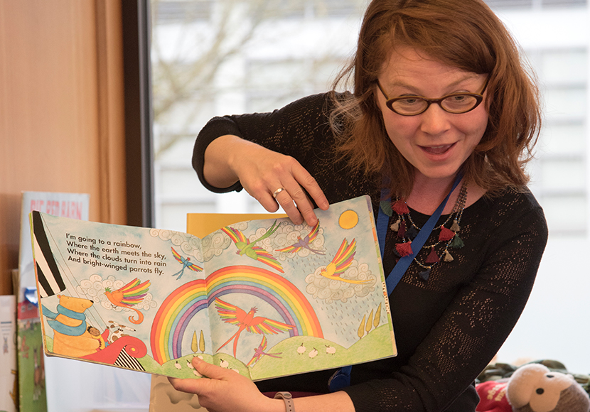 Librarian reading to kids at Rainbow Story Time